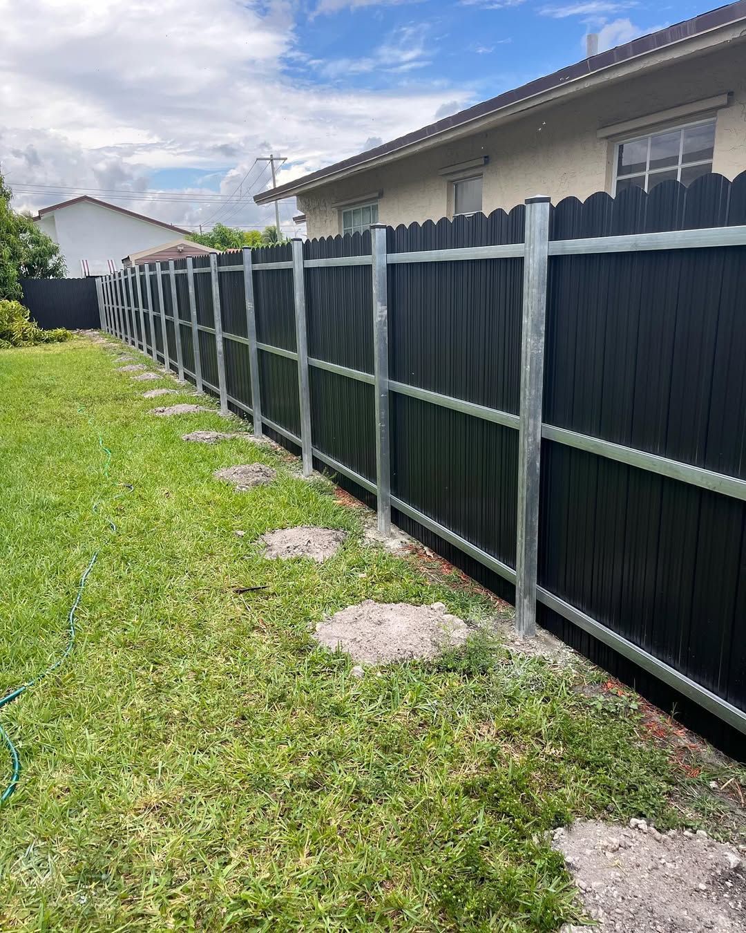 Corrugated metal fence